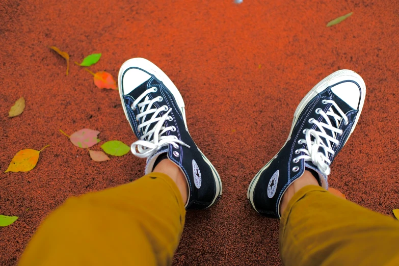 person standing on the red ground with their shoes off