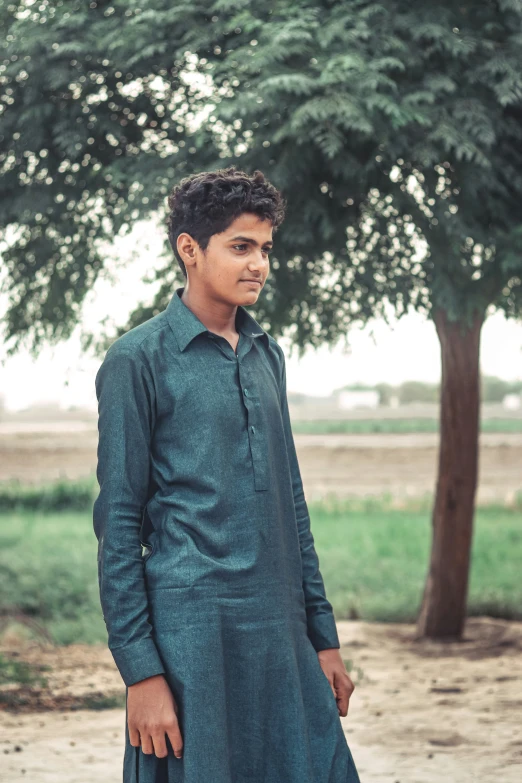 a man in green is standing in the dirt