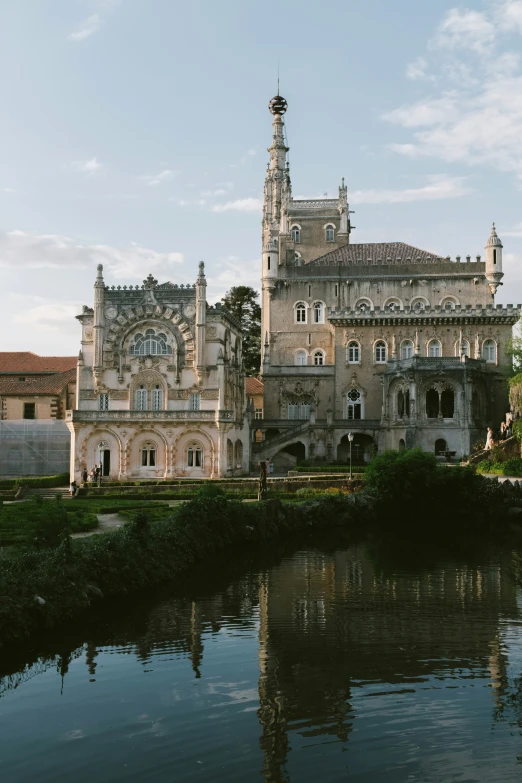 an ornate house on the edge of water