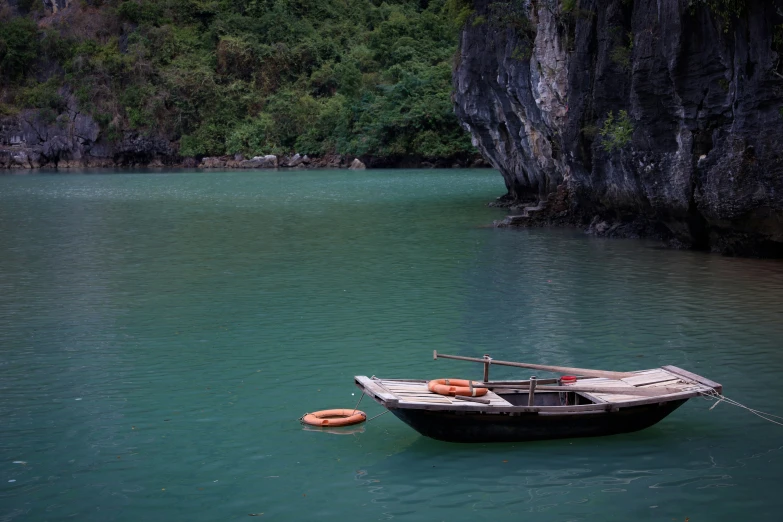 a boat sitting on the edge of a body of water