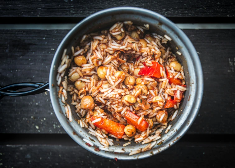 a silver pot full of food and a spoon