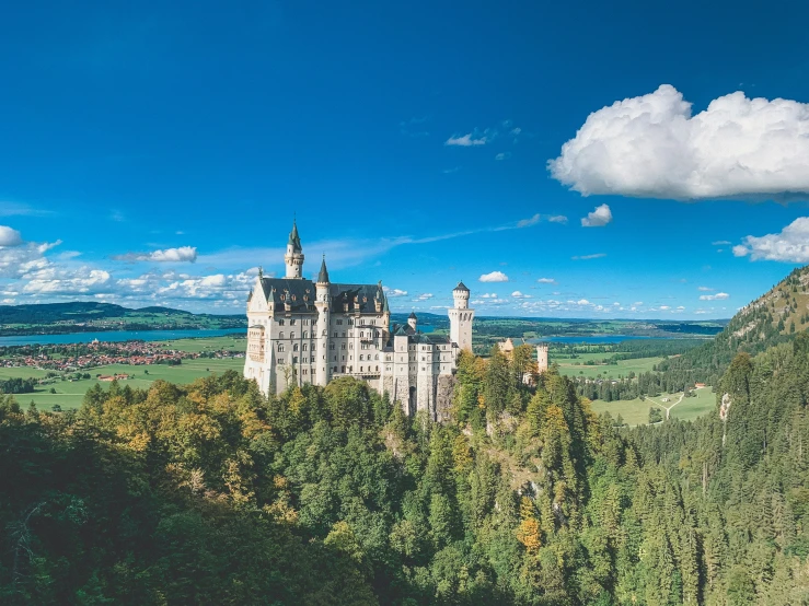 a castle is sitting on top of a hill