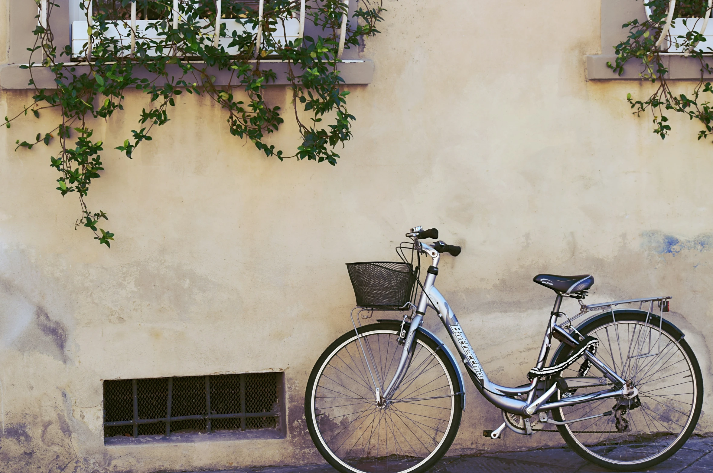 a bicycle is parked outside the side of a building