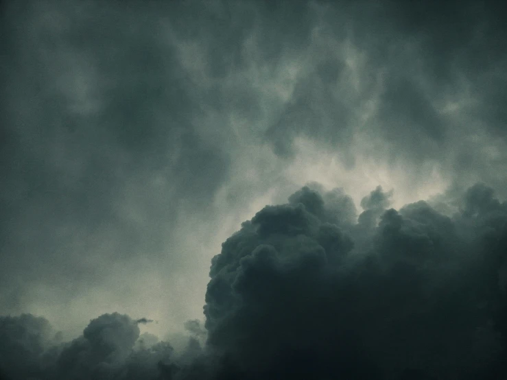 a black sky with the dark clouds behind it