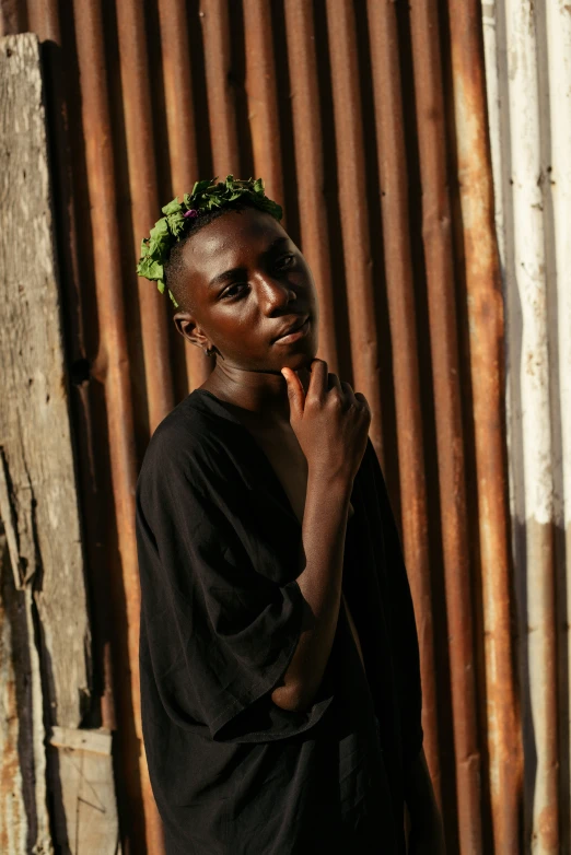 an african man standing in front of a building