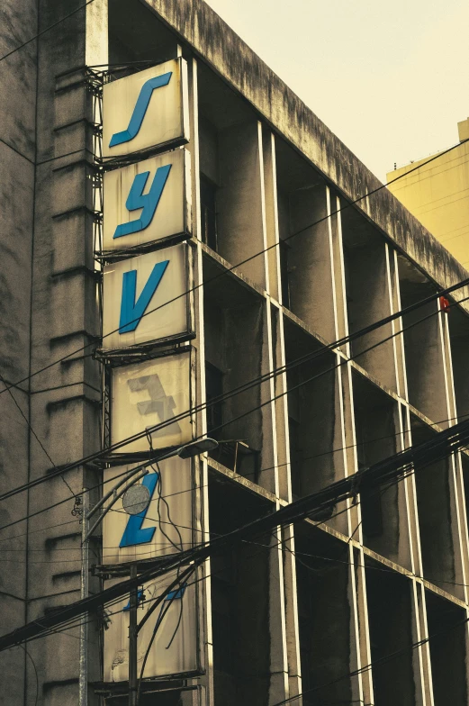 an old building has graffiti and blue letters