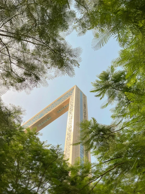 a very tall building surrounded by lots of trees