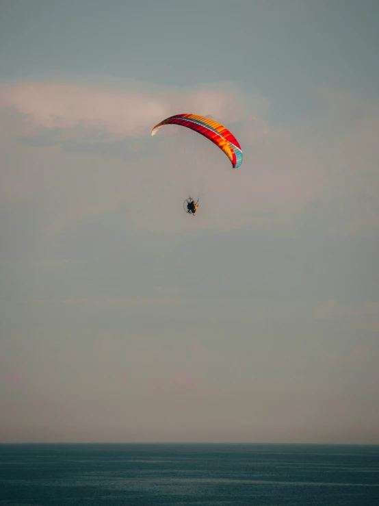 two para sailers in the middle of an ocean