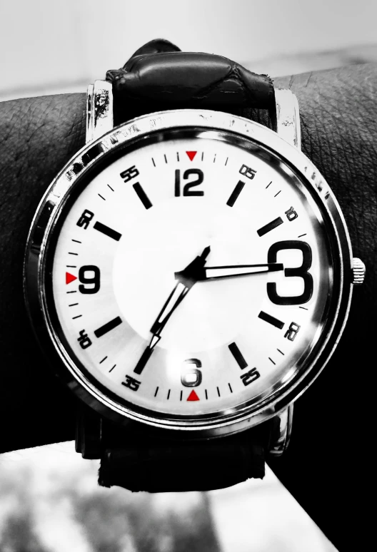 an analog watch is being displayed on the wrist