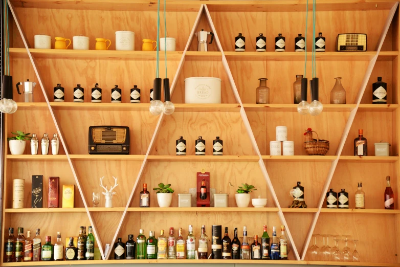 a row of wooden shelves holding bottles of liquor