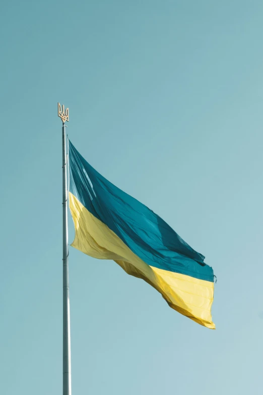 a large green and yellow flag flying in the air