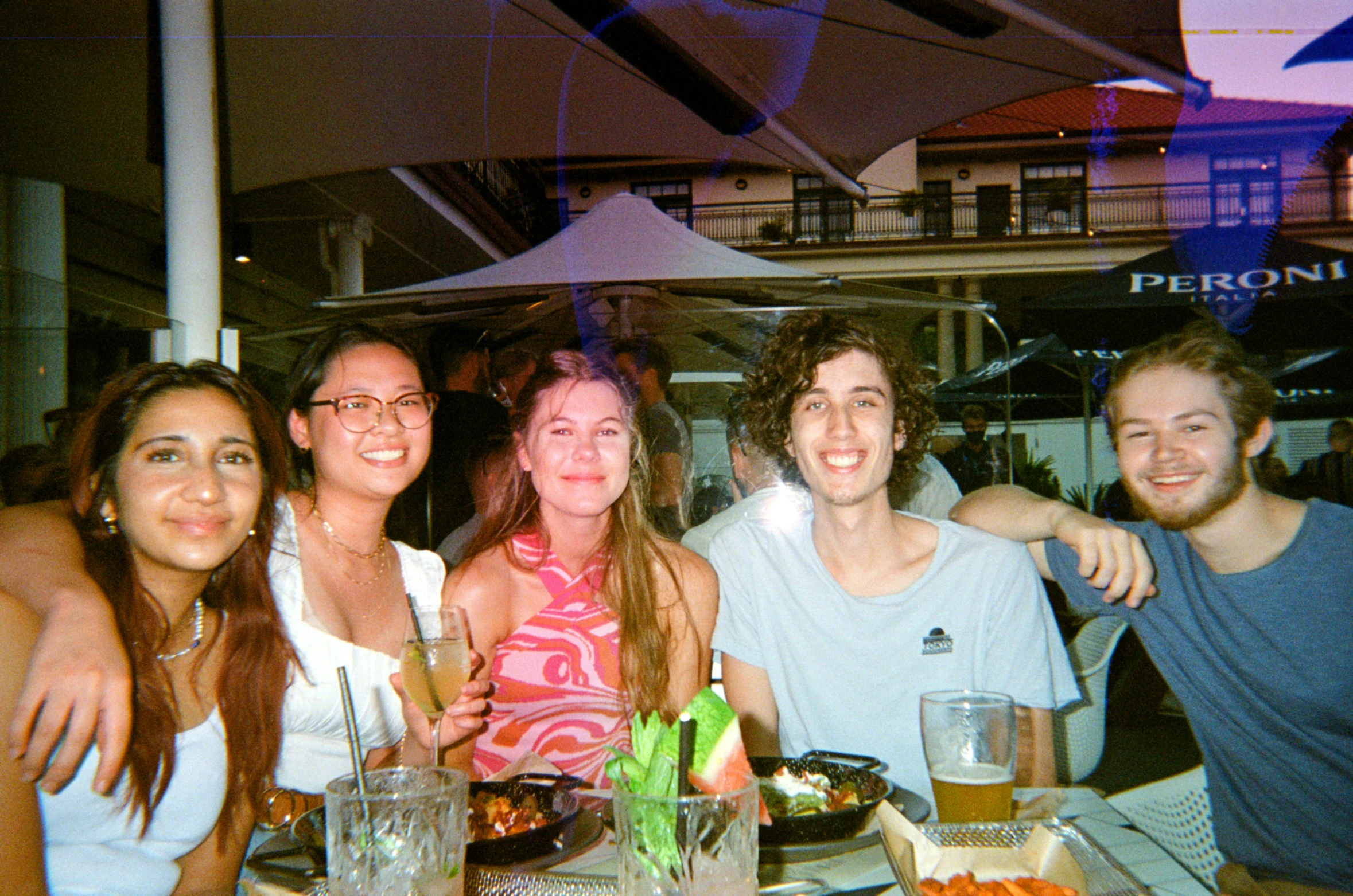 people sitting at a table posing for a po