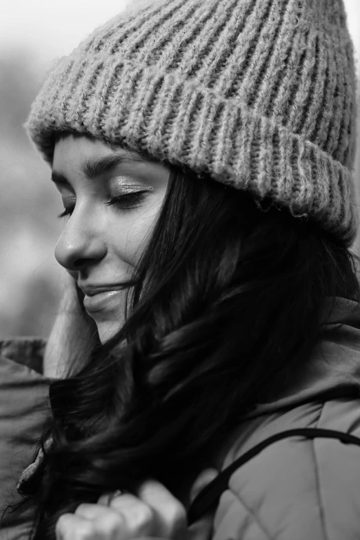 the woman smiles while she talks on her cell phone