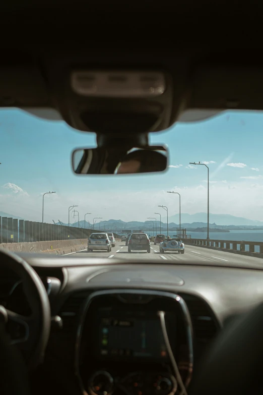 a vehicle on the side of a road that has a bridge in the background