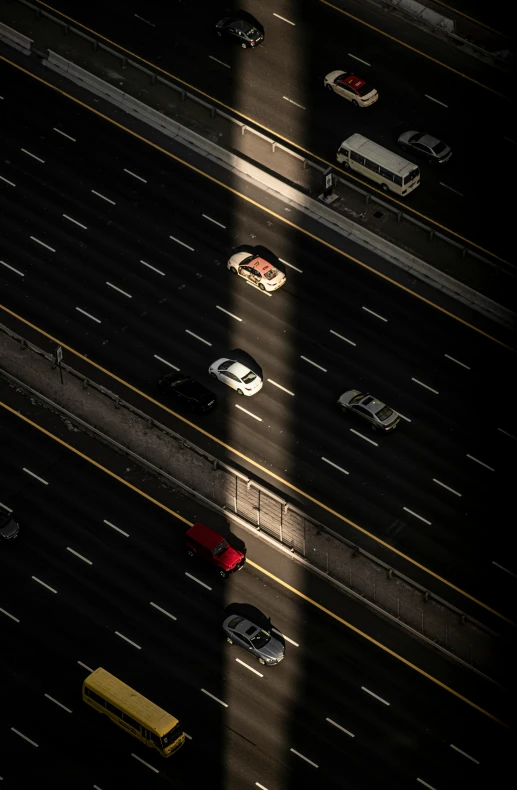 a couple of cars on the road with long shadows