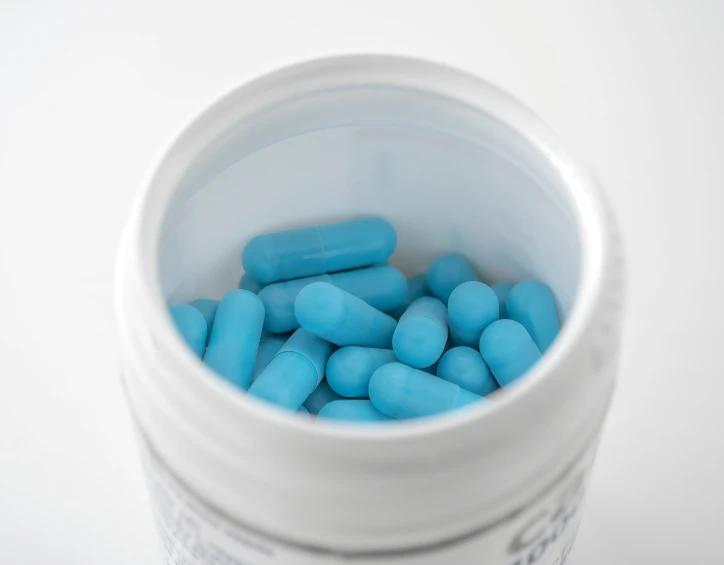 pills inside a bottle are blue in color