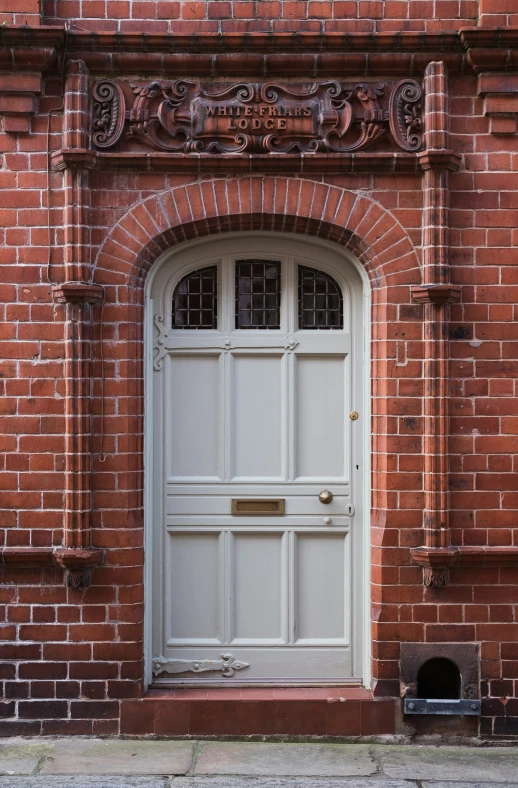 the doorway is made of brick and holds a doghouse