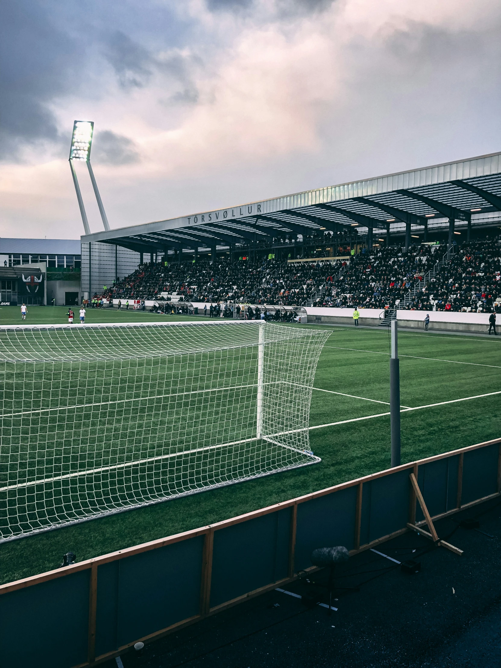 the goalie stand at a soccer game in a cloudy sky