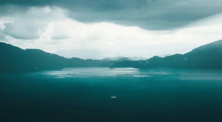 boat in the water under a cloudy sky