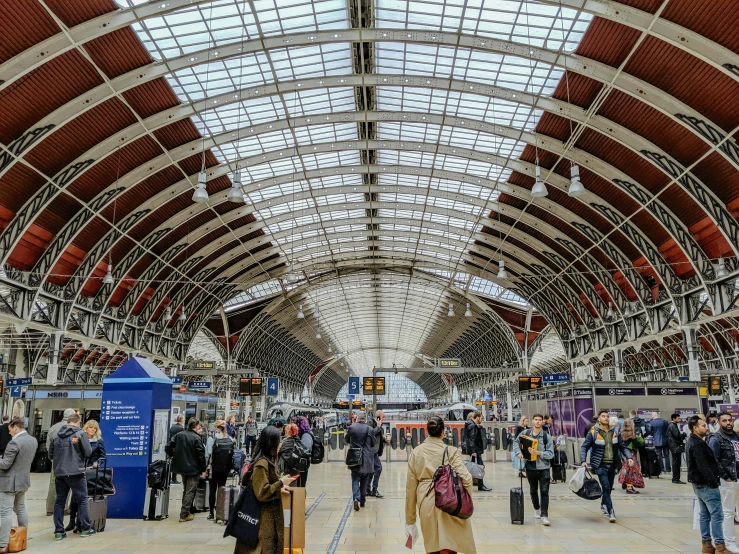 an airport full of people walking through a busy lobby