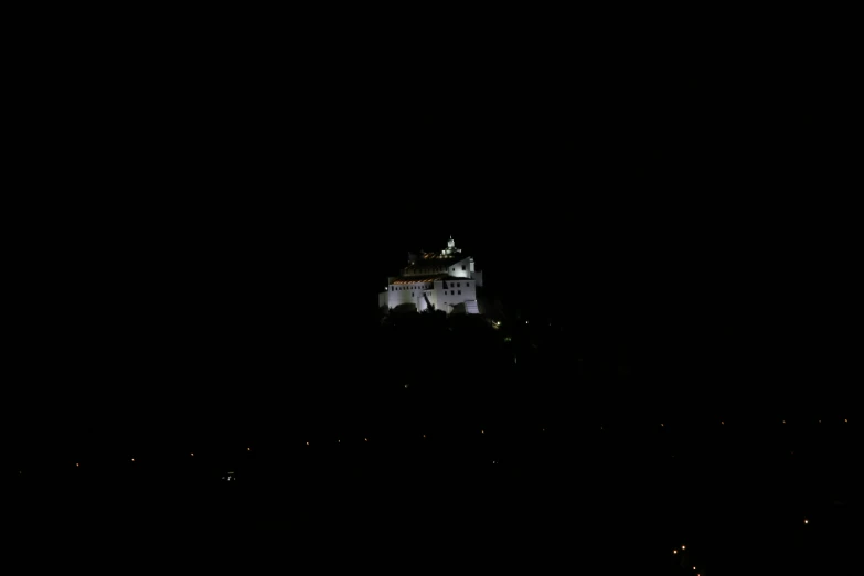 dark view of a castle on top of a hill