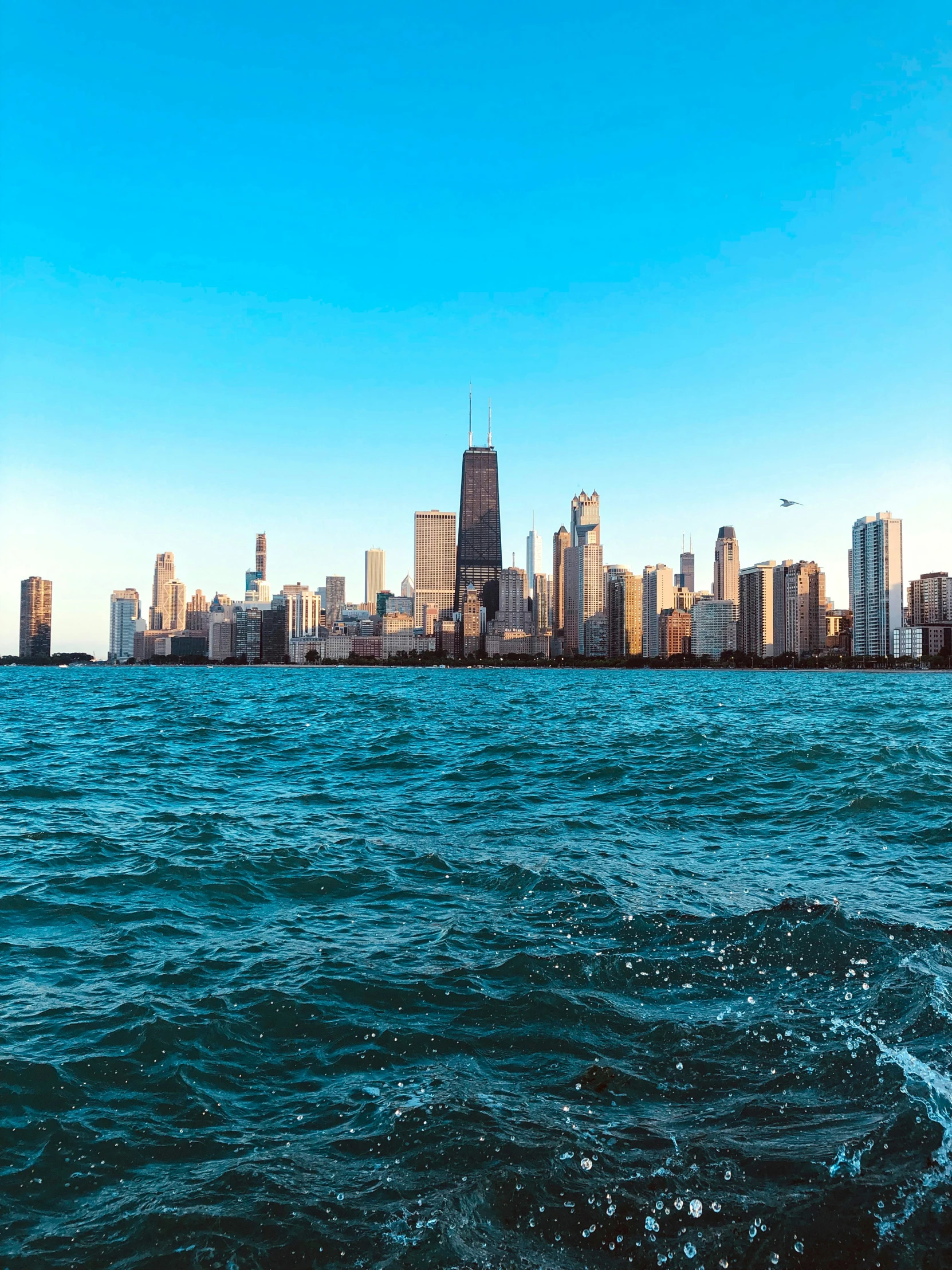 a sail boat on a body of water in front of a city