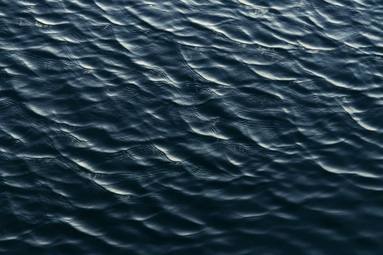 some water on a blue sky with ripples in it