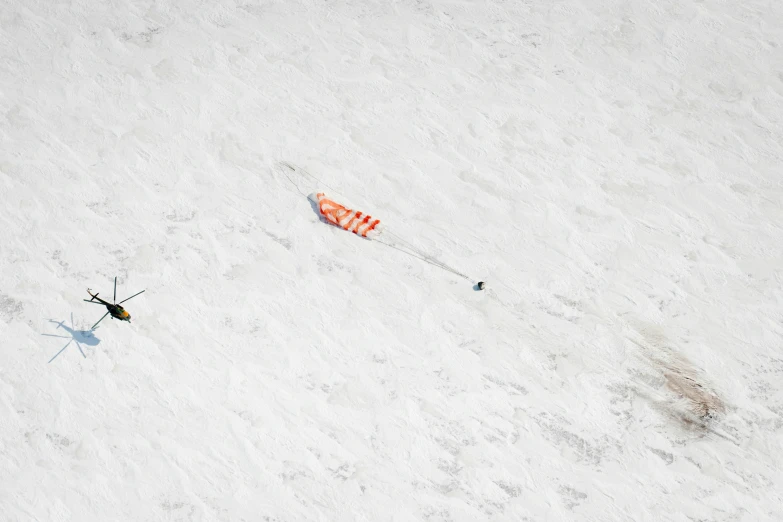 the orange flag is attached to an object in the snow