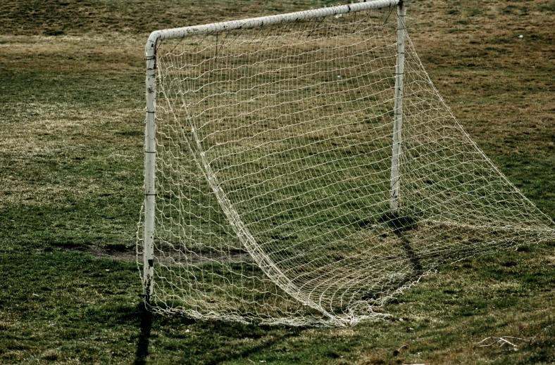 a soccer goalie net sitting in a field