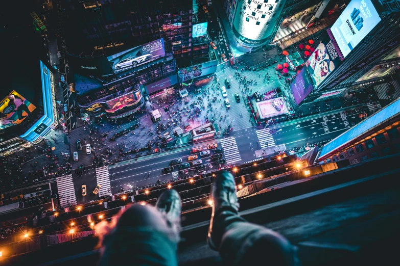 people stand in the middle of a large city intersection