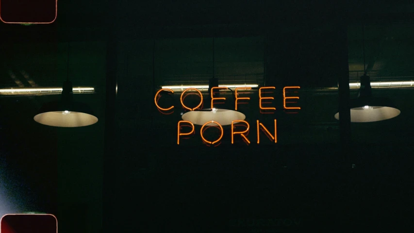 a sign saying coffee porn sitting above tables