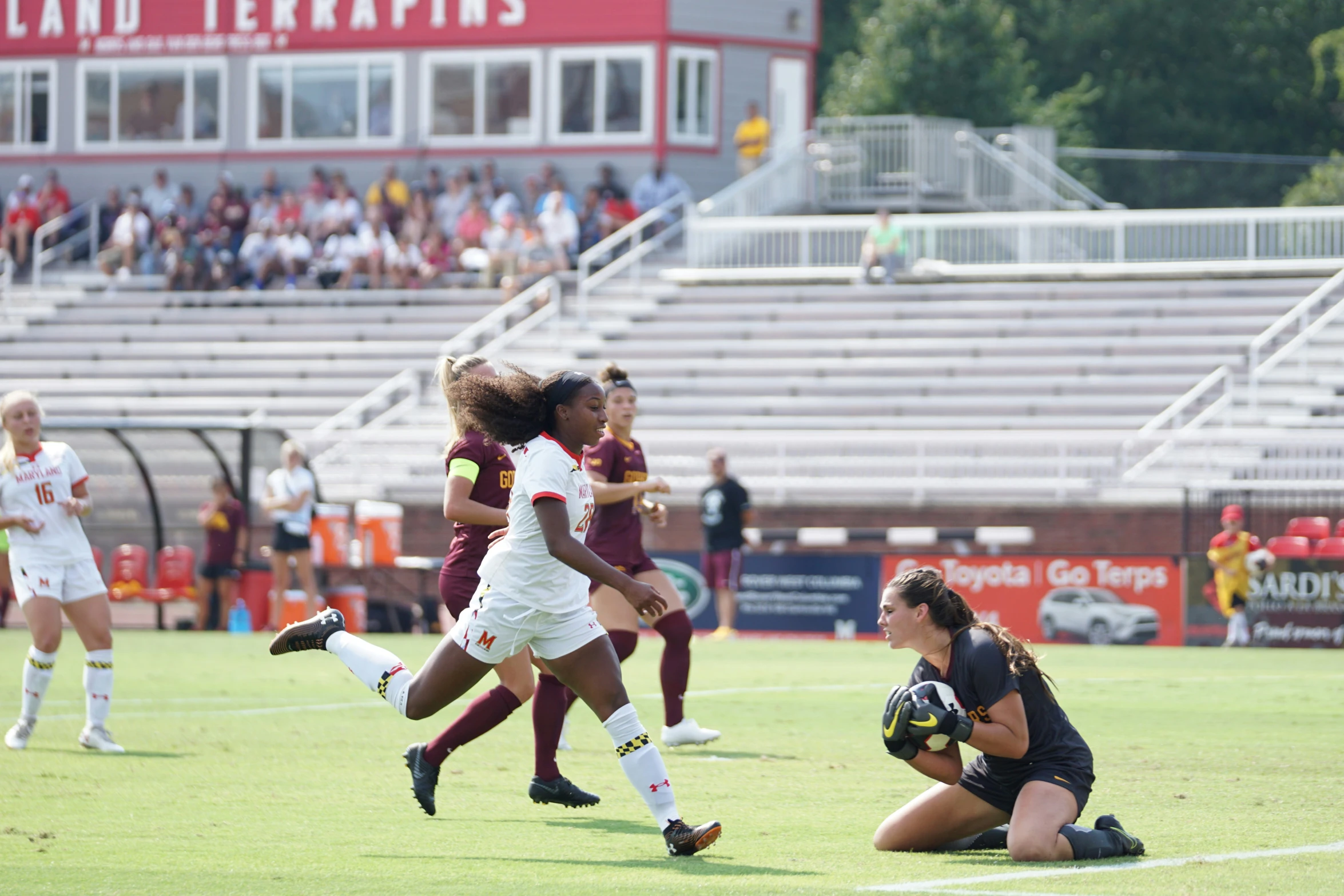 there are two female soccer players competing for the ball