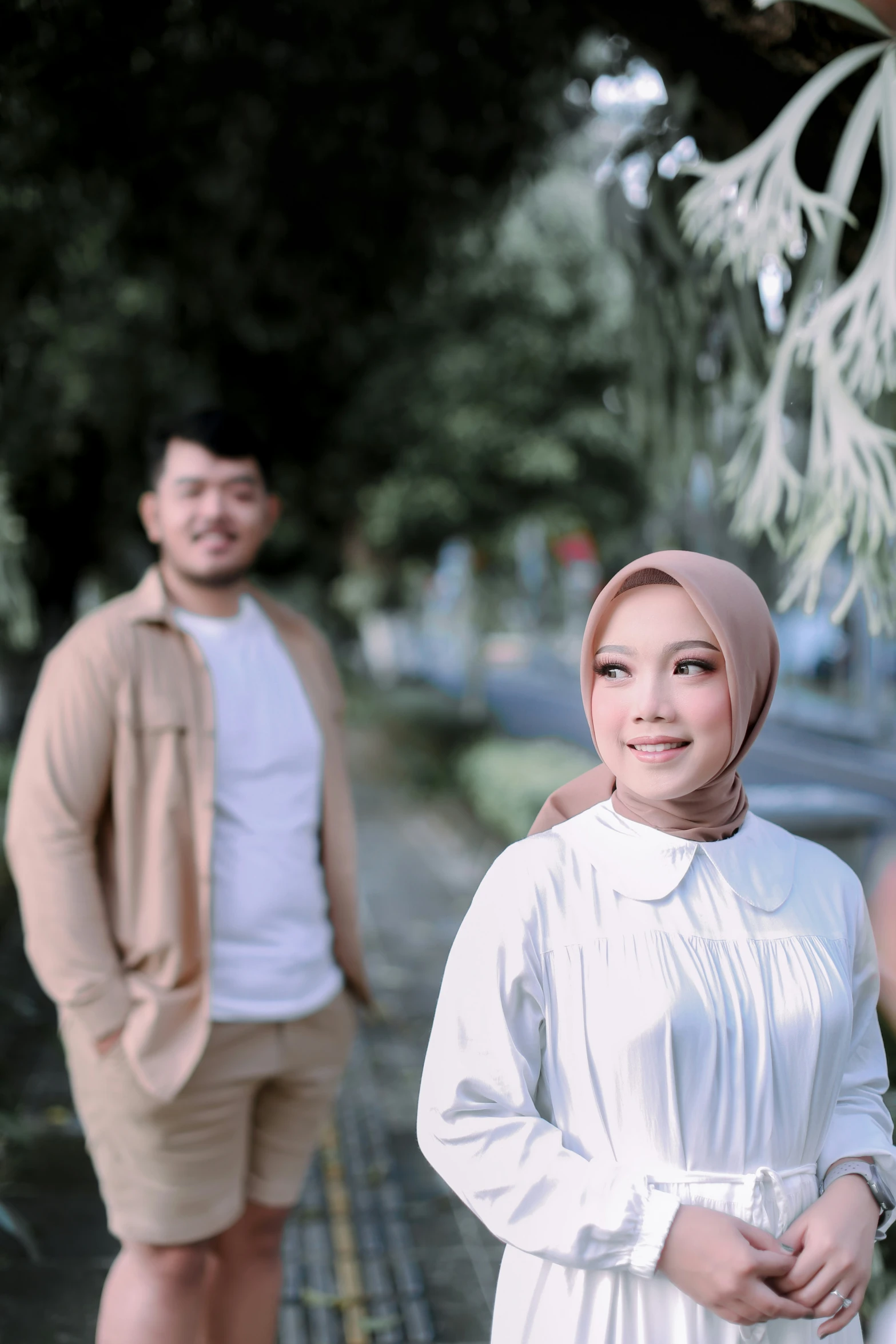 a man and a women standing near a building