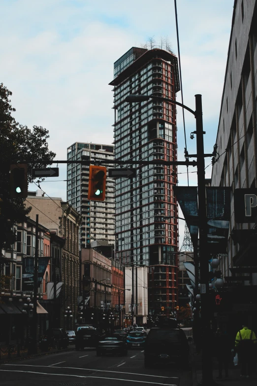 a street in a city with a very tall building under construction