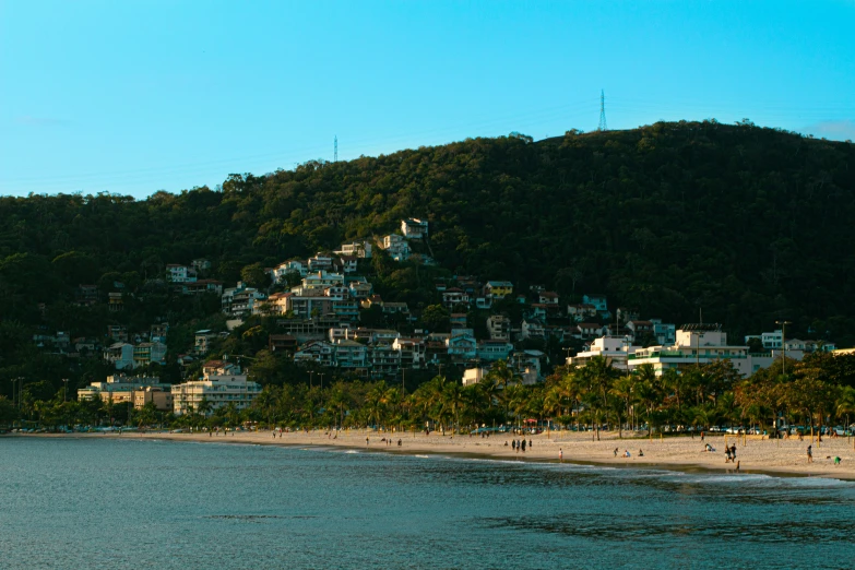 a group of people on the beach next to a city