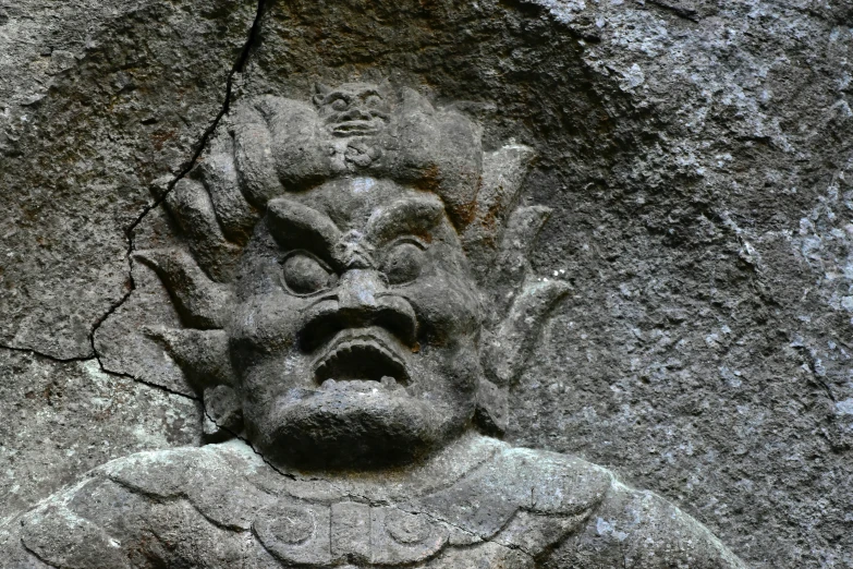 a sculpture in stone that looks like a face