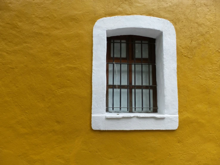 the window of an old building with bars on it