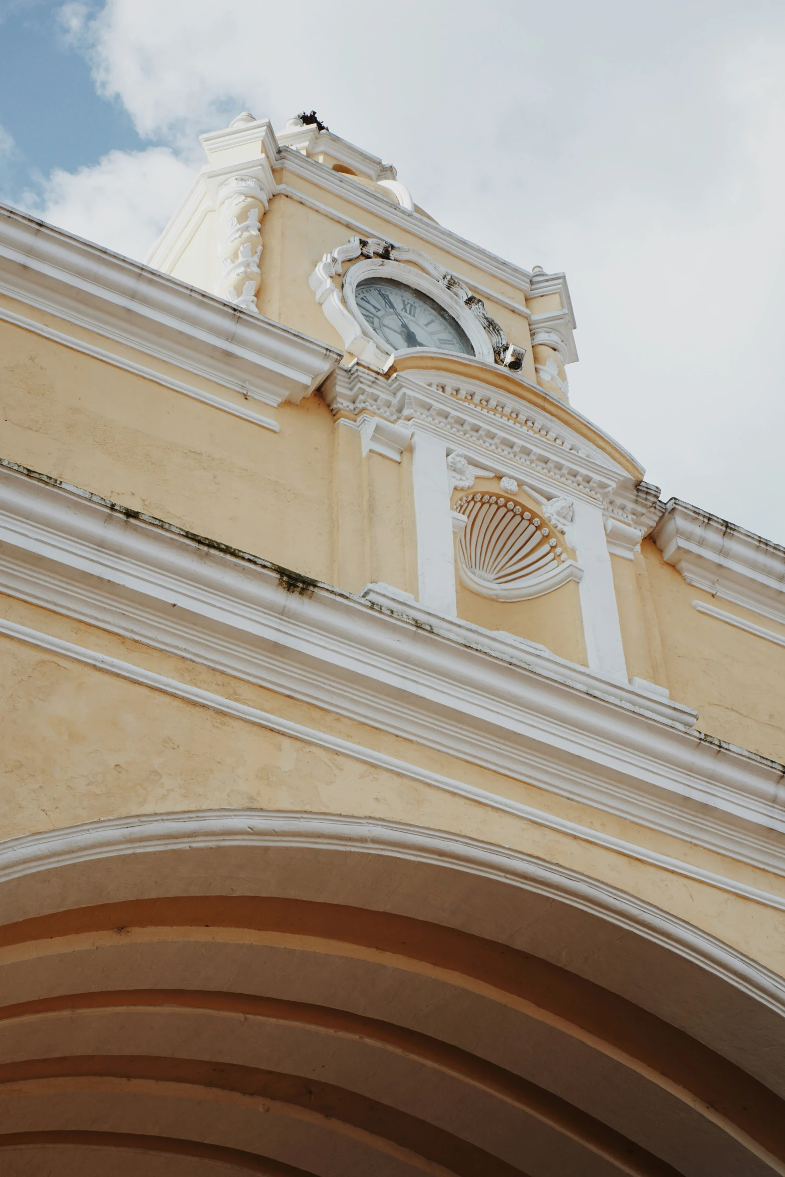 a clock on top of a building under a cloudy sky