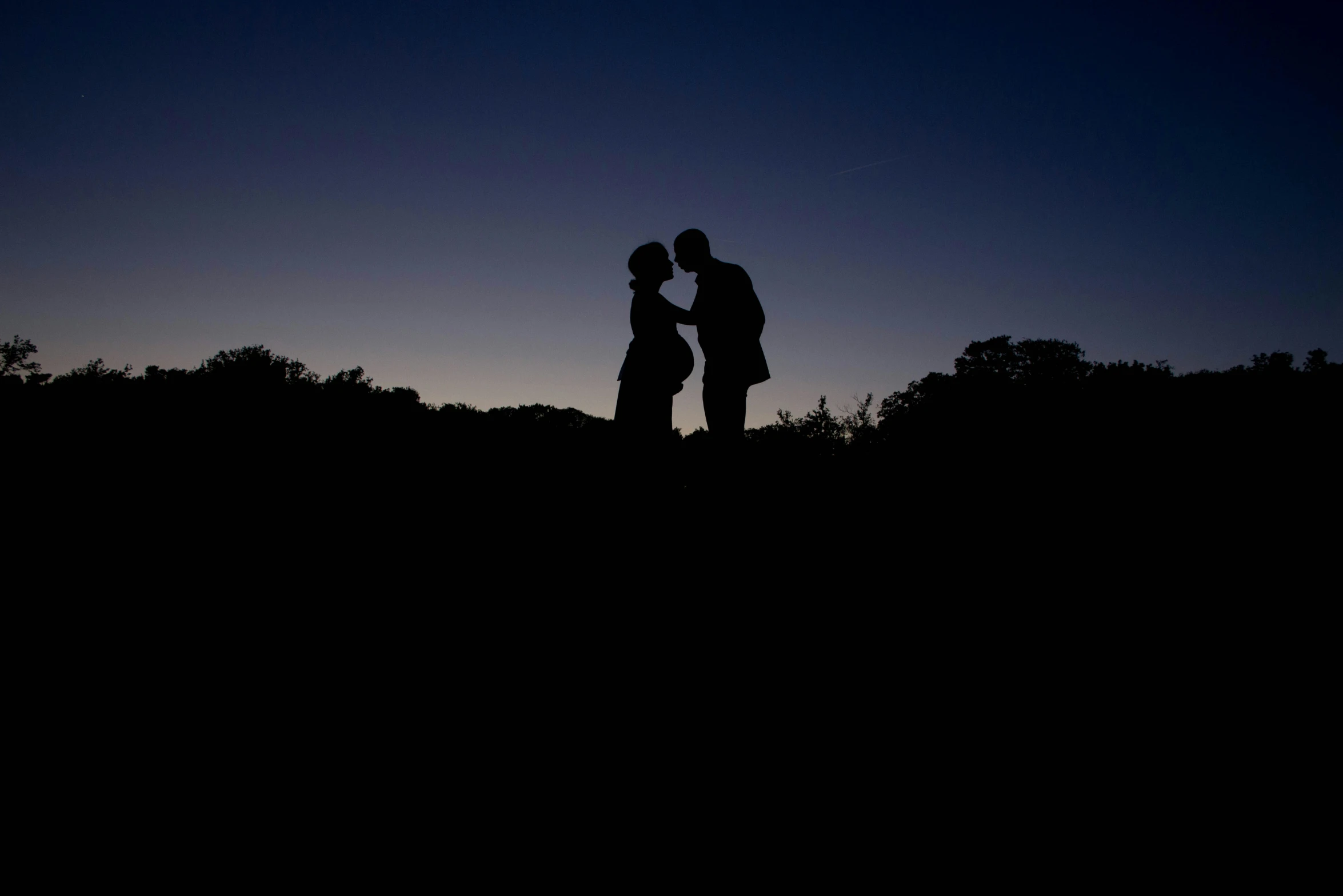 two people standing together, and one woman holding the other