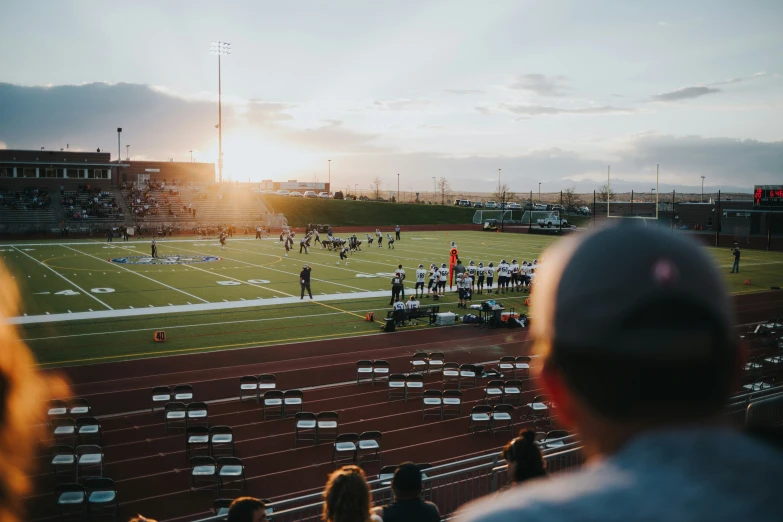 the sun shines bright in the background as people watch on