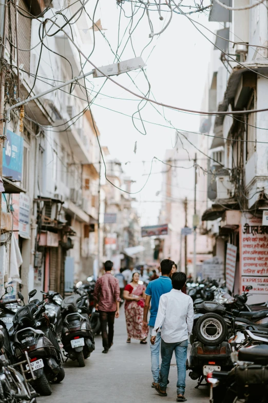 a city street filled with lots of motorcycles and pedestrians