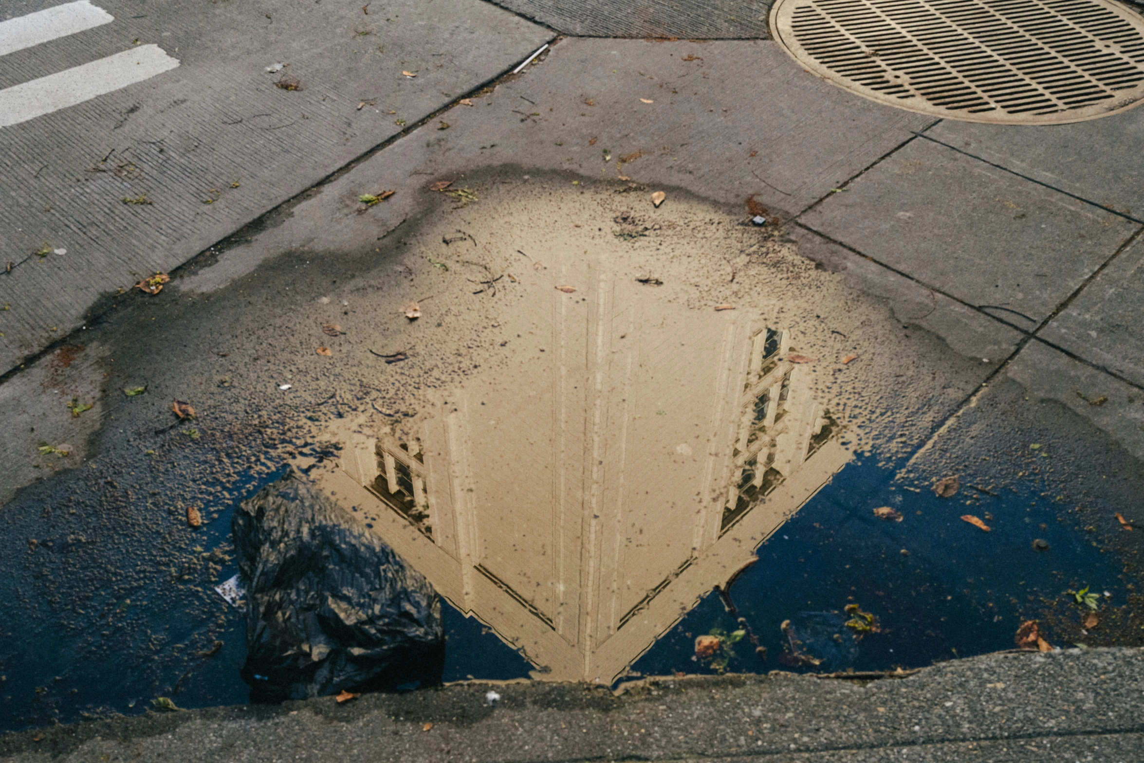 a manhole with a drain cover on the ground