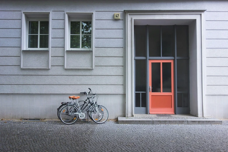 two bikes are locked to each other in front of a building