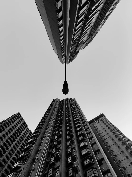 a view from the bottom of a skyscr with a drop hanging from it