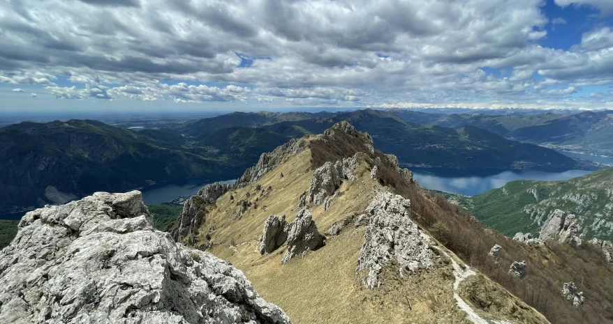 a couple of hikers look out over some mountain tops