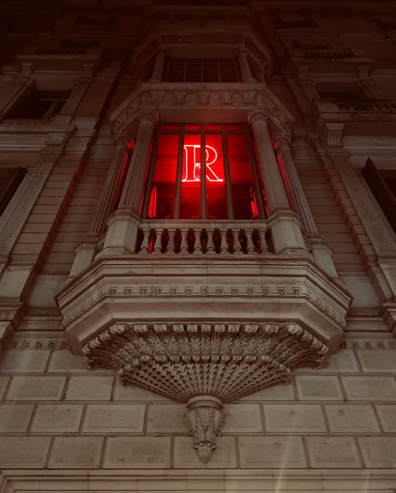 a building with red light is pictured in a dark image