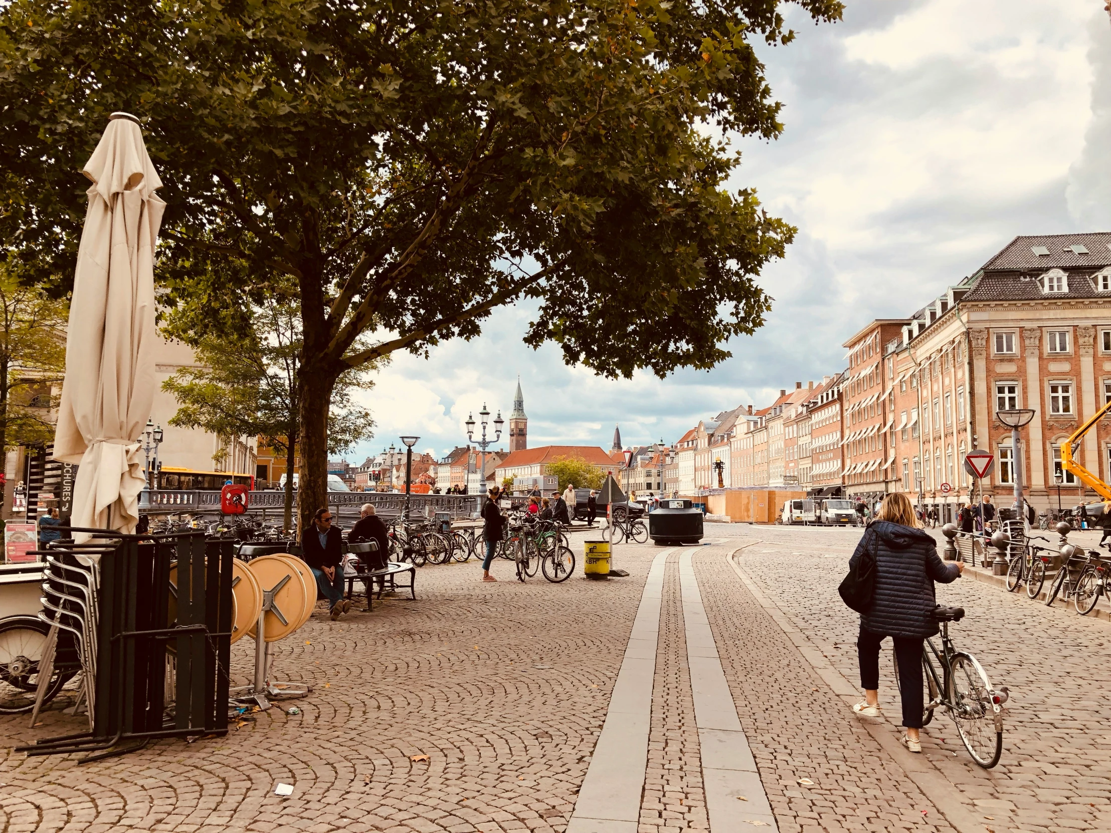 a man rides his bicycle through an open city square