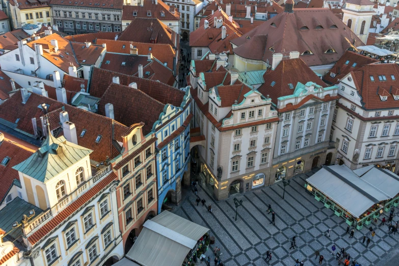 a city with several buildings and tents on the sidewalk