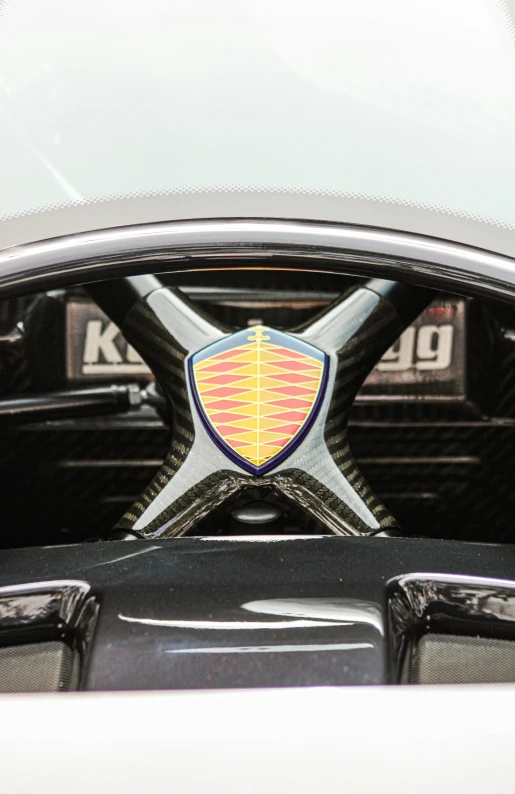 front badge on a white car with a red crest