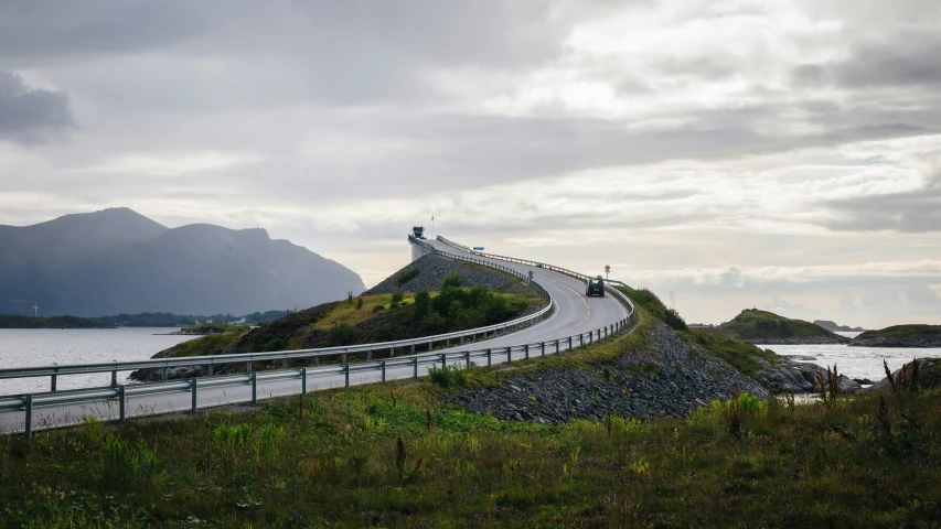 a narrow winding paved road near the ocean